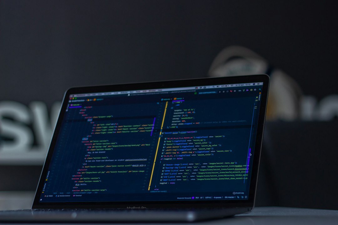 software developer coding on laptop